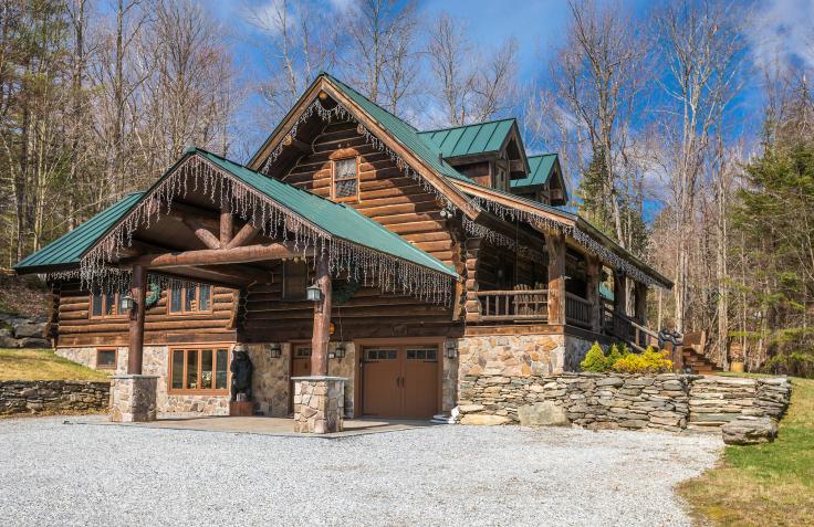 Brown Vermont Log Cabin with green roof