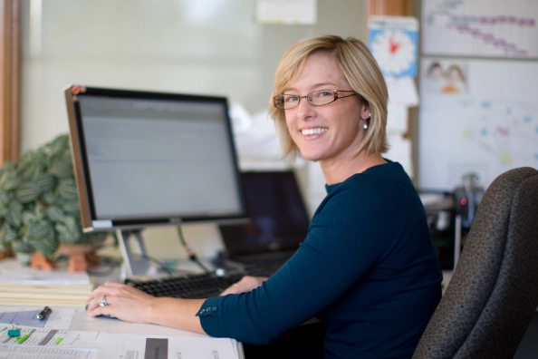 Smiling woman working at computer.
