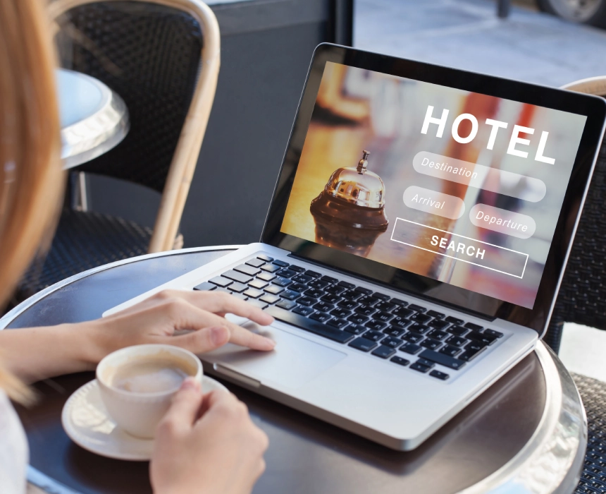 Woman booking hotel online on laptop.